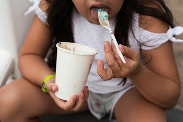 girl eating ice cream with spoon