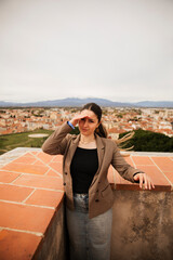 Girl posing with the houses of the city of Perpignan in the background