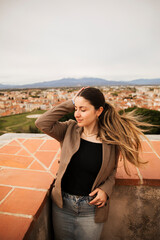 Fototapeta na wymiar Girl posing with the houses of the city of Perpignan in the background