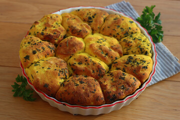 Turmeric curcuma and parsley bread . Healthy turmeric Bread in a cake pan on a gray striped napkin on wooden table
