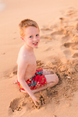 Little boy playing in the sand on beach