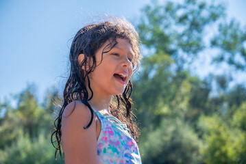 Young girl laughing while swimming at river