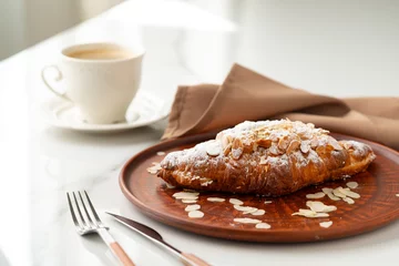 Gordijnen Almond Croissant on clay plate close up © fotofabrika