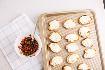 Cheese topped crostini ready for tomato mixture