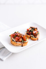 Balsamic glaze topped bruschetta on a plate
