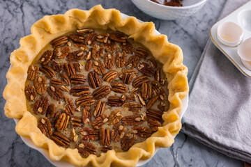 Pecan pie on marble ready to bake