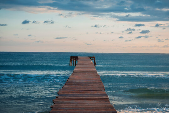 tranquil scenery of a lonely dock at Playa de Muro Mallorca Spain in the morning 