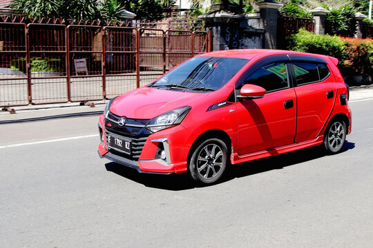 Jakarta, Indonesia - 1 April 2024: Red Color compact city car  Daihatsu Ayla on the Road, in Cilandak Area, Jakarta