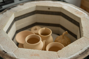 Fototapeta na wymiar Ceramic dishes in a special kiln. School of Ceramics.