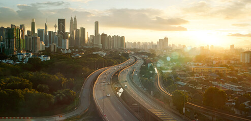 Golden hour over city skyline and highway