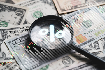 Magnifier glass to focus on 100 USD dollar banknote with update and down arrow for Federal or FED increase and decrease percentage of interest to reduce inflation crisis concept.