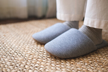 Fototapeta na wymiar Closeup of a woman wearing slippers at home