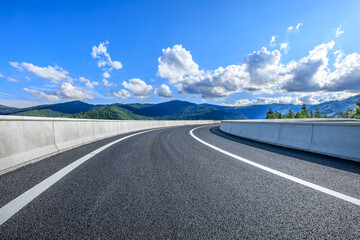 Asphalt highway road with mountain nature landscape on a sunny day