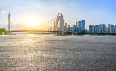 Asphalt road and city skyline with modern buildings scenery at sunset in Guangzhou