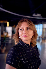 stunning model in business mini dress posing in modern office space