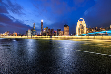 Asphalt road with modern city buildings scenery at night in Guangzhou. Road and city buildings...