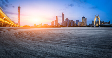 Asphalt road square and city skyline with modern buildings scenery at sunset in Guangzhou. Panoramic view.