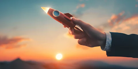Fotobehang Businessman control rocket is launching and soar flying out from hand to sky for growth business, Fast business success, Startup business concept © samina