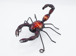 Metal wall art of a scorpion arachnid,  red, purple deep brown color with pinchers claws and tail...