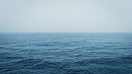 A boundless view of the ocean's horizon under the soft light of dusk, illustrating the vastness of the sea..