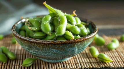 Edamame placed in a bowl on a bamboo mat