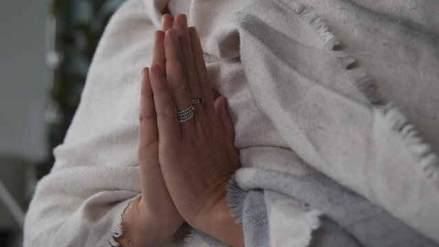 A meditating woman holding her hands together