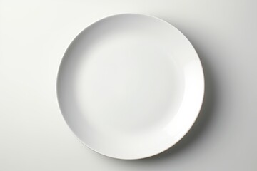 A white plate rests gracefully on a wooden table, radiating simplicity and sophistication