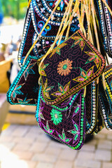 Vibrant embroidered Turkish bags on display, traditional patterns