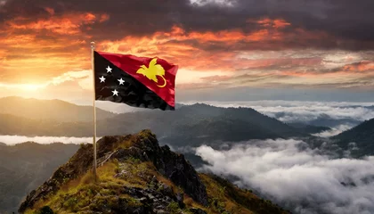 Fototapete The Flag of Papua New Guinea On The Mountain. © Daniel