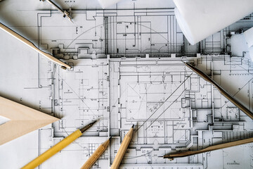Architectural engineering design plan drawing on the table. Architect's work on table in studio. Construction design and plan