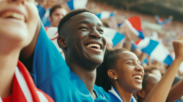 French Football or soccer fans cheer and support their team on tribune in football stadium