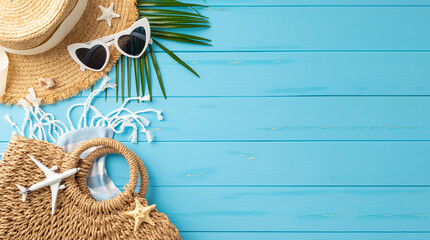 Beach vacation accessories such as straw hat, sunglasses, bag and palm leaf arranged on a vibrant...
