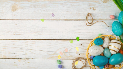 Happy easter banner. Colored Easter eggs on a wooden background. Copy space