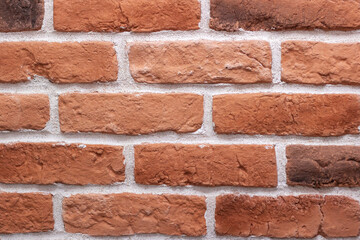 Closeup of a symmetrical pattern of brown brickwork rectangles