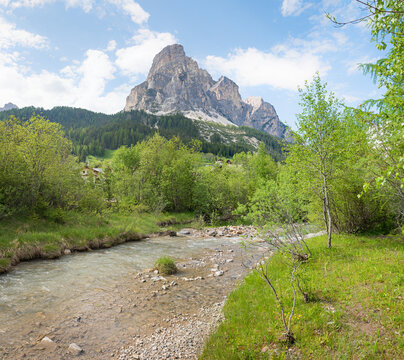 spring landscape with River Gader and view to Sassongher mountain, Corvara