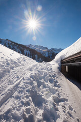 winter landscape tyrol, skiing tracks and snowbound hut, bright sunshine - 786938964