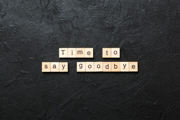 Time to say goodbye word written on wood block. Time to say goodbye text on cement table for your...