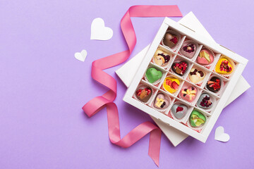 Valentine day composition: sweet candy, with gift boxes with bow and red felt hearts, photo template, background. Top View with copy space