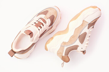 Pair of stylish sneakers on light background close-up top view.