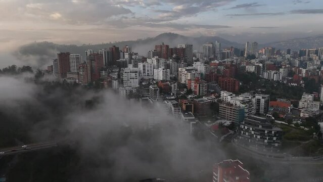 Aerial drone video view footage of Qutio early morning sunrise capital city of Ecuador La Carolina Park traffic Catedral Metropolitana de Quito south american skyline