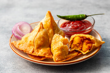 selective focus Samosa, Spiced potato-filled pastry, crispy, Savory, popular Indian snack serve with tomato sauce. 
