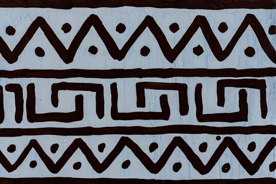 African drawing on a white wall with ornaments, closeup