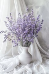 A simple white vase with vibrant purple flowers. Suitable for home decor or gardening themes