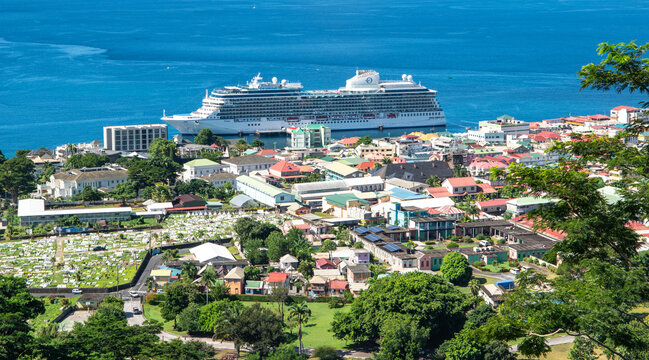 Roseau, Dominica - November 24, 2023: Cityscape with cruise ship Oceania Vista in harbor of Roseau Dominica. 