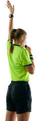 Back view. Young serious woman, soccer referee blowing a whistle and raising hand up as free kick symbol isolated on transparent background. Concept of sport, game, competition, tournament