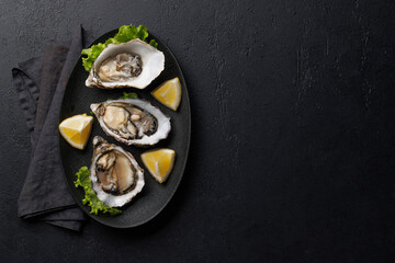 Fresh oysters with lemon on plate