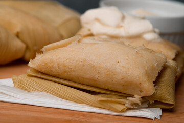 Latin America, Central American tradition: savory tamales wrapped in corn leaves, served with creamy goodness, a taste of El Salvador