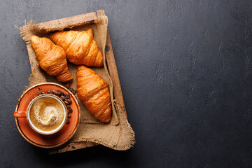 Fototapeta na wymiar Cappuccino coffee and fresh croissants