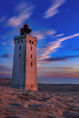 Sunset at the lighthouse Rubjerg Knude Fyr near Lokken in Denmark. - obrazy, fototapety, plakaty