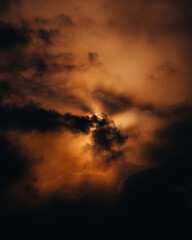 Fototapeta premium Heavenly rays pierce the cloud cover, creating a feeling of hope. The bright rays of the sun break through the clouds, creating a dramatic effect. Shine.